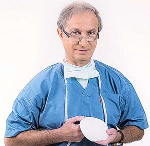 the doctor holds the breast augmentation prosthesis